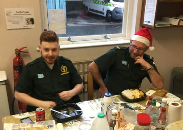 Aaron McCracken, left, polishes off his Christmas dinner while Brian McCafferty prepares to tuck in to his.