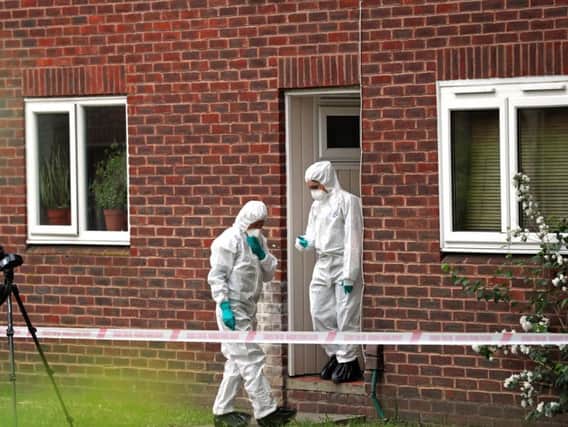 Forensics officers at the scene in Hanworth, west London where a mother and baby were stabbed on Monday evening